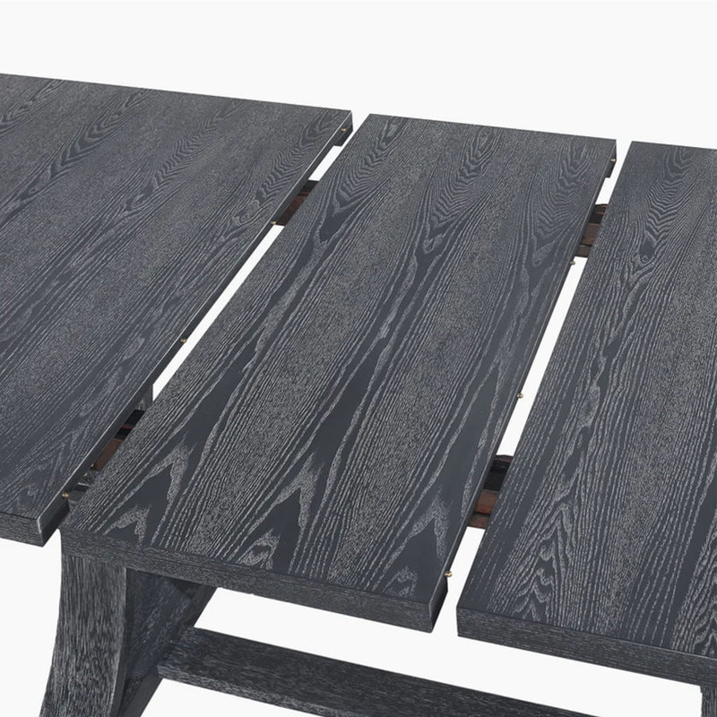 Rustic gray Devingo extendable dining table by Noble House, showing the tabletop with extension leaf and sturdy wooden legs.
