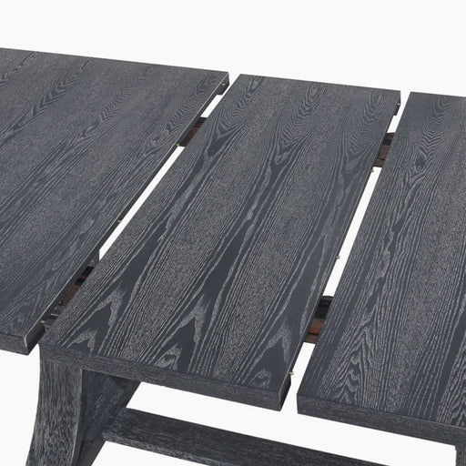 Rustic gray Devingo extendable dining table by Noble House, showing the tabletop with extension leaf and sturdy wooden legs.