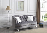 Glory Furniture Jewel loveseat in plush fabric, showing its elegant stationary design with curved arms and cushioned seating.