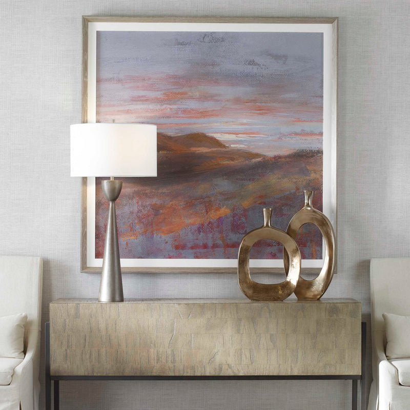 Framed print titled "Dawn On The Hills" by Uttermost, featuring a purple mountain landscape artwork with a sleek frame.