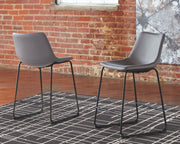 Set of two Signature Design by Ashley Centiar upholstered barstools with padded seats and backrests, perfect for kitchen or bar area.