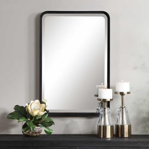 Uttermost Croften black vanity mirror with a sleek, modern design, featuring a round reflective surface and stylish black frame.