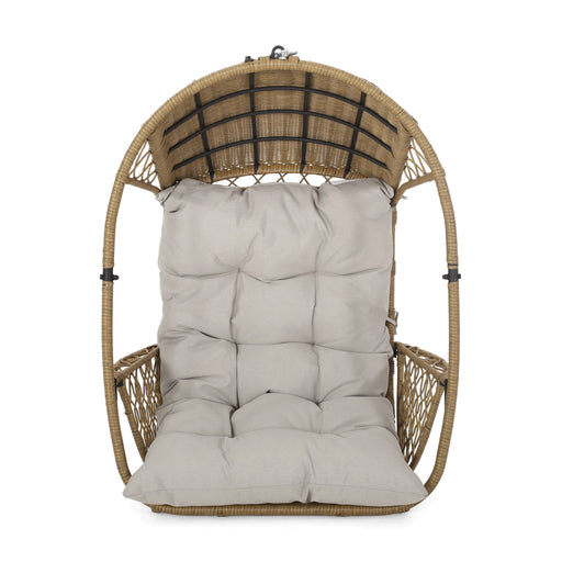 Noble House Malia wicker hanging chair with beige cushion, suspended from a sturdy frame, ideal for outdoor relaxation.