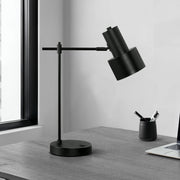 Modern black 8th Street table lamp with USB port, featuring a sleek design and illuminated shade, perfect for bedside or desk use.