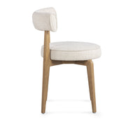 Cream fabric side dining chair by TOV Furniture with sleek design and plush upholstery, ideal for modern dining spaces.