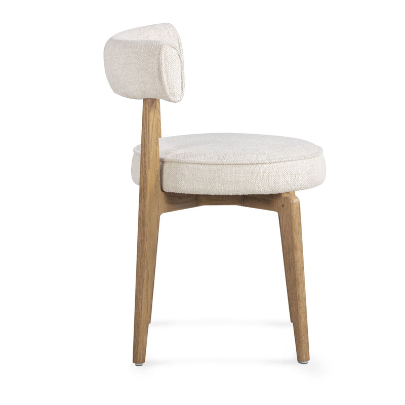 Cream fabric side dining chair by TOV Furniture with sleek design and plush upholstery, ideal for modern dining spaces.