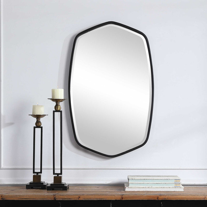 Uttermost Duronia iron wall mirror with a sleek, modern frame, hanging on a neutral wall for stylish home decor.