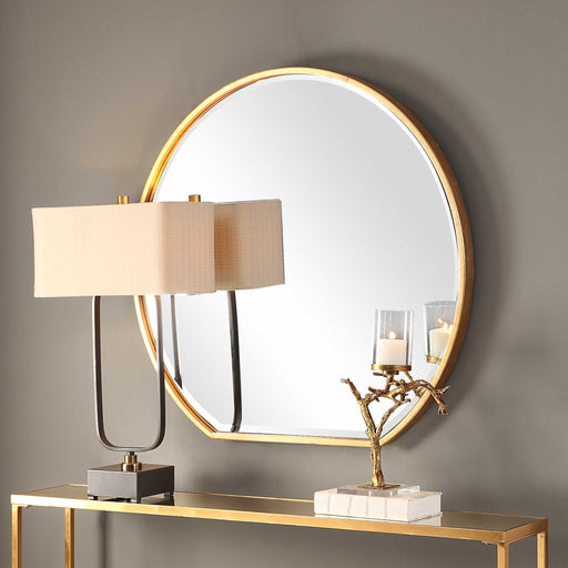 Uttermost Cabell wall mirror with a sleek, modern frame, hanging on a wall, showcasing its stylish design and reflective surface.