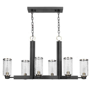 Black Jarsdel 6-light industrial island pendant lighting by Uttermost, featuring a sleek, modern design with metal shades.
