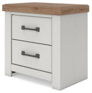 Benchcraft Savonport two-drawer night stand with charging station in white and brown wood finish, featuring sleek modern design.