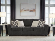 Loreo stationary sofa by Benchcraft® with plush cushions and modern design, shown in a contemporary living room setting.