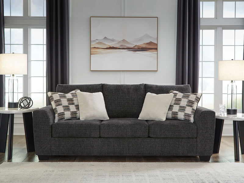 Loreo sofa sleeper by Benchcraft® with plush cushions and neutral fabric, designed as a versatile sleeper sofa for living rooms.