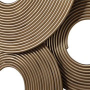 Gold rings wall decor by Uttermost, featuring overlapping gold metal rings mounted on a neutral wall for modern interior style.