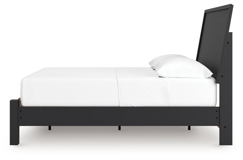 Signature Design by Ashley Danziar panel bed with low footboard, showcasing a sleek wooden frame and modern design.