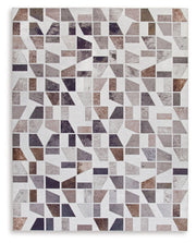 Signature Design by Ashley Jettner area rug with geometric pattern in neutral tones, showcasing soft woven fabric and decorative edges.