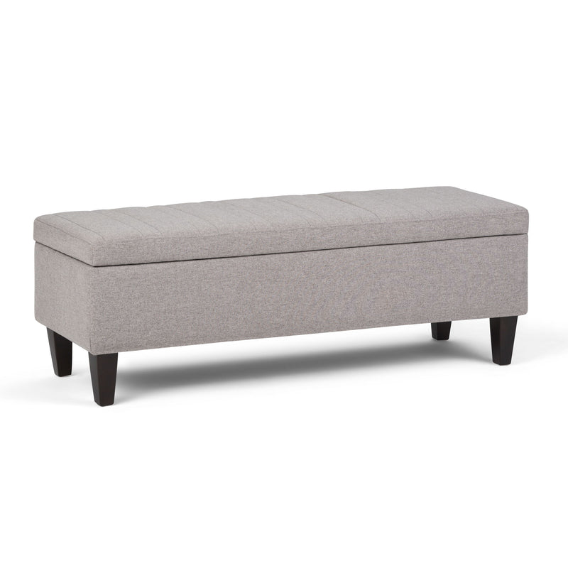 Simpli-Home Monroe upholstered storage ottoman with a soft fabric top and wooden legs, functional and stylish for living room.