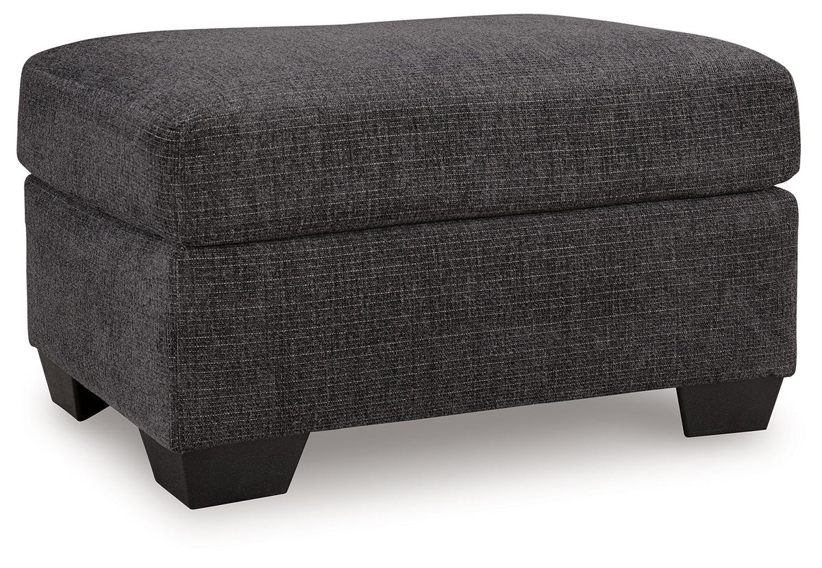 Benchcraft® upholstered ottoman with plush fabric and wooden legs, perfect as a versatile living room accent piece.