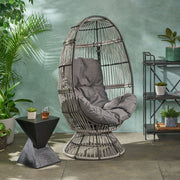Noble House patio swivel basket egg chair with cushion, outdoor accent chair for relaxing in the garden or patio setting.