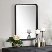 Uttermost Croften black vanity mirror with a sleek rectangular frame, designed for elegant bathroom or bedroom decor.