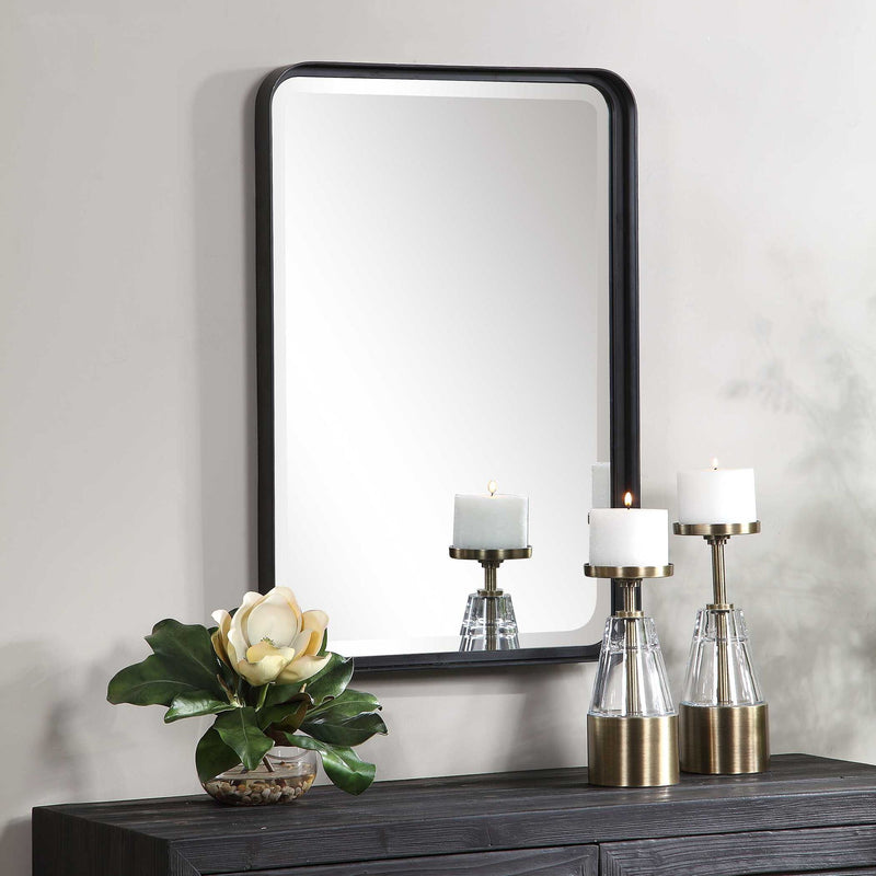 Uttermost Croften black vanity mirror with a sleek rectangular frame, designed for elegant bathroom or bedroom decor.