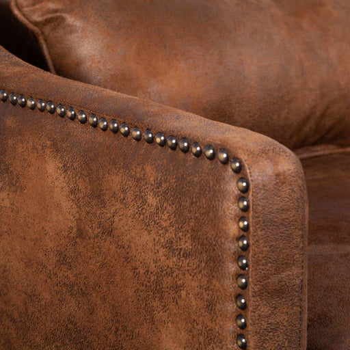 Dark brown leather armchair from Uttermost featuring a classic design and plush cushioning for comfortable seating.