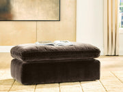 Benchcraft® Maxton Heights upholstered ottoman with padded fabric top and wooden legs, versatile for living room decor.