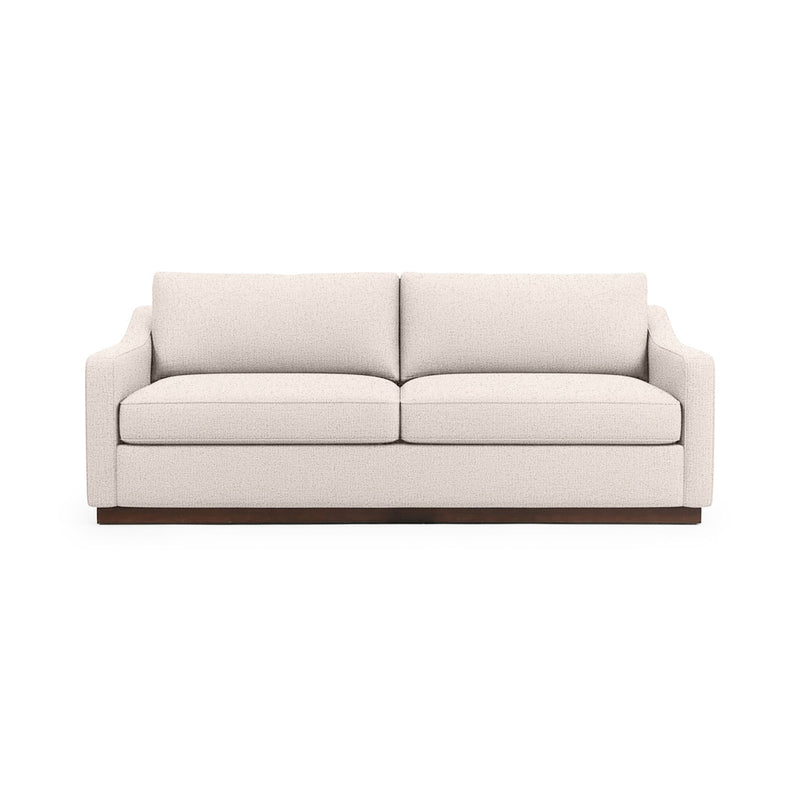 Classic Home Aspen stationary sofa with plush cushions and neutral fabric, showcasing a modern living room setup.