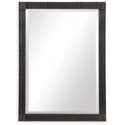 Uttermost Gower vanity mirror in aged black with a sleek, modern design reflecting natural light and interior decor.