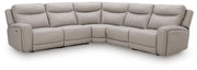 Benchcraft® Gravier reclining sectional sofa with plush cushions and reclining features in a modern living room setting.