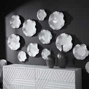Set of three ceramic wall decor pieces from Uttermost featuring abstract, textured designs for modern interior accents.