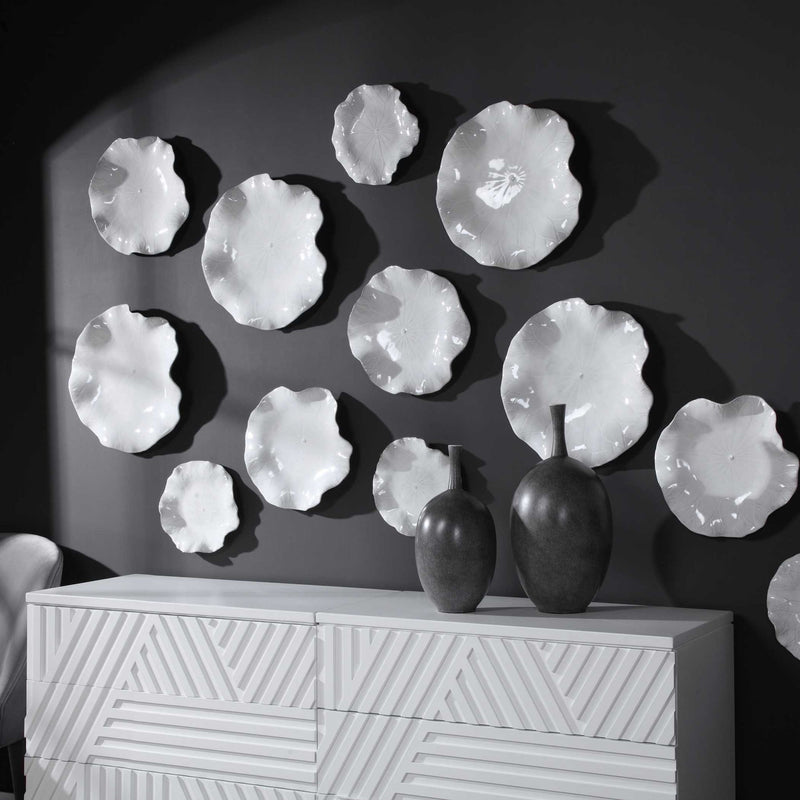 Set of three ceramic wall decor pieces from Uttermost featuring abstract, textured designs for modern interior accents.
