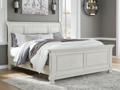 Robbinsdale Signature Design by Ashley 6-piece sleigh bed bedroom set with matching nightstands and dresser in a classic wood finish.