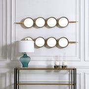 Uttermost wall mirror with a sleek button-style frame, reflecting modern decor and stylish design.