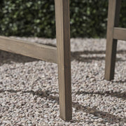 Two weather-resistant Acacia wood Adirondack dining chairs by Noble House, outdoor seating set with wide armrests and slatted backrests.