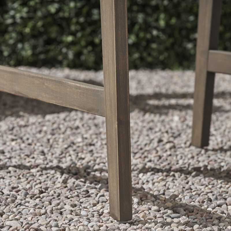 Two weather-resistant Acacia wood Adirondack dining chairs by Noble House, outdoor seating set with wide armrests and slatted backrests.