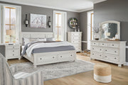 Ashley Robbinsdale Sleigh 6-piece bedroom set with a sleigh bed, dresser, mirror, nightstands, and matching furniture in a classic design.
