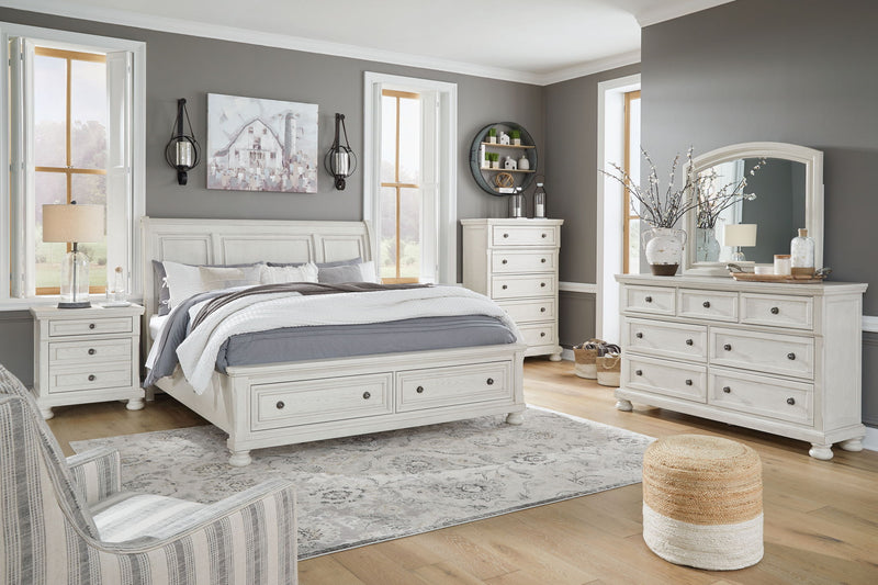 Ashley Robbinsdale Sleigh 6-piece bedroom set with a sleigh bed, dresser, mirror, nightstands, and matching furniture in a classic design.