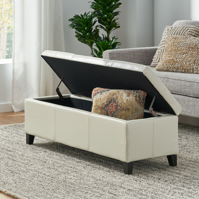 Noble House Glouster contemporary storage ottoman with a padded fabric top and wooden legs, suitable for living room storage.