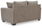 Benchcraft stationary loveseat by Loreo with plush fabric and comfortable cushions, perfect for cozy living room seating.