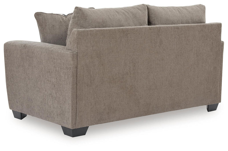 Benchcraft stationary loveseat by Loreo with plush fabric and comfortable cushions, perfect for cozy living room seating.