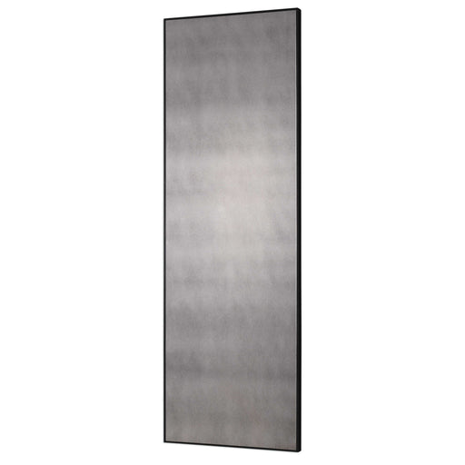 Uttermost Burwell oversized black antiqued wall mirror with a bold, antique-inspired frame hanging on a wall.