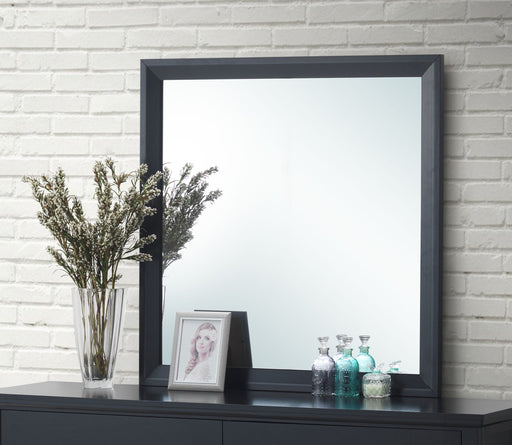 Glory Furniture Primo mirror with sleek rectangular frame, wall-mounted design, reflecting a modern interior style.