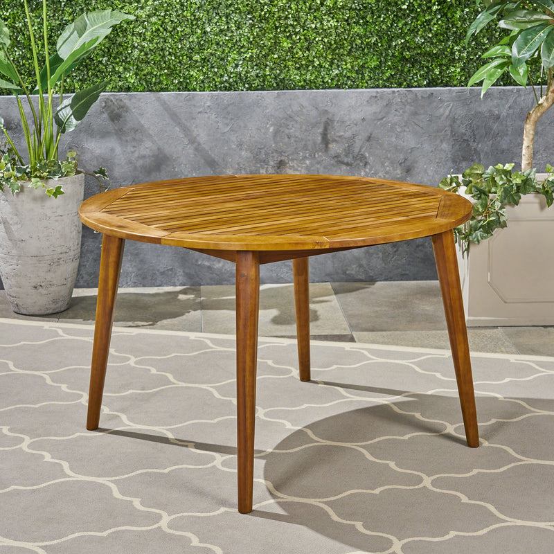 Noble House Stamford outdoor dining table with modern design, featuring a sleek rectangular surface and sturdy metal legs.