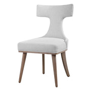 Pair of white Klismos accent chairs by Uttermost, featuring elegant wooden legs and curved backrests for stylish seating.