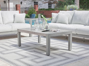 Signature Design by Ashley Hurley Park coffee table with a sleek wooden surface and sturdy black metal frame.
