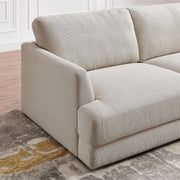 Ashcroft Furniture Glander cozy sectional sofa in beige with plush cushions and wide armrests, perfect for a comfortable living room.