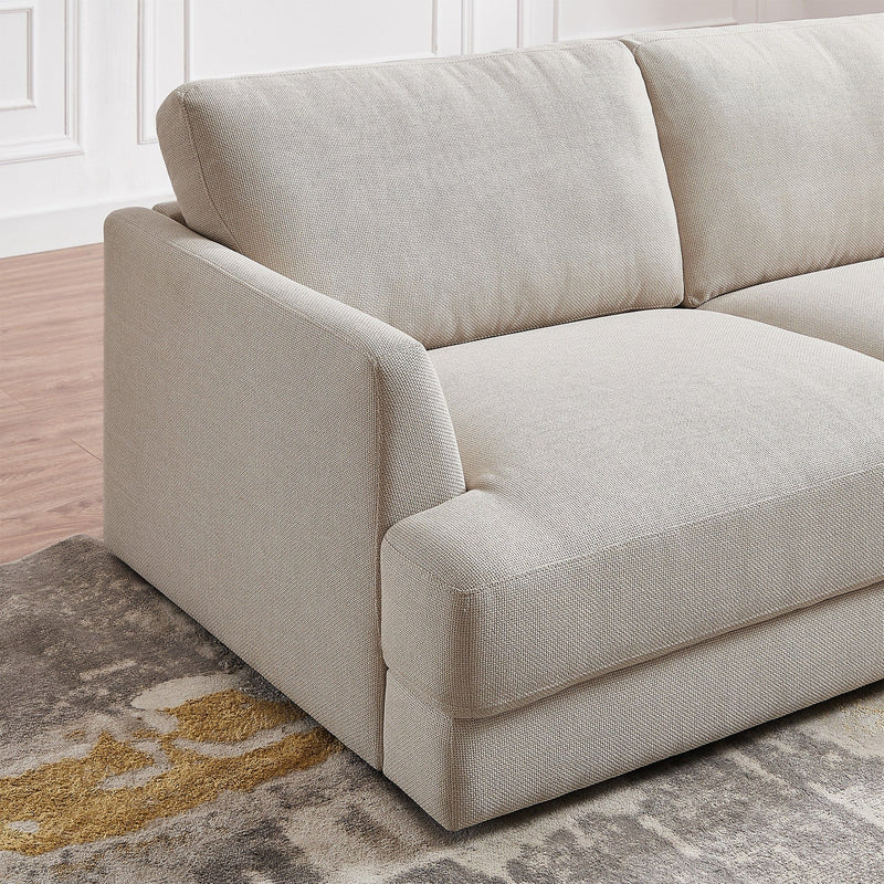 Ashcroft Furniture Glander cozy sectional sofa in beige with plush cushions and wide armrests, perfect for a comfortable living room.