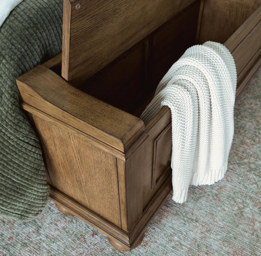 Signature Design by Ashley Karallin panel storage bed with built-in drawers and modern wood finish, showcasing its sleek design and storage features.