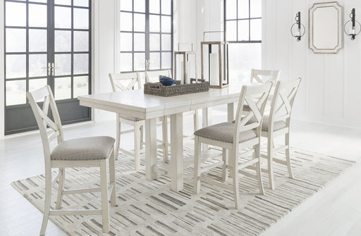 Signature Design by Ashley Robbinsdale rectangular counter height dining extension table set with six matching chairs in a modern dining room setting.