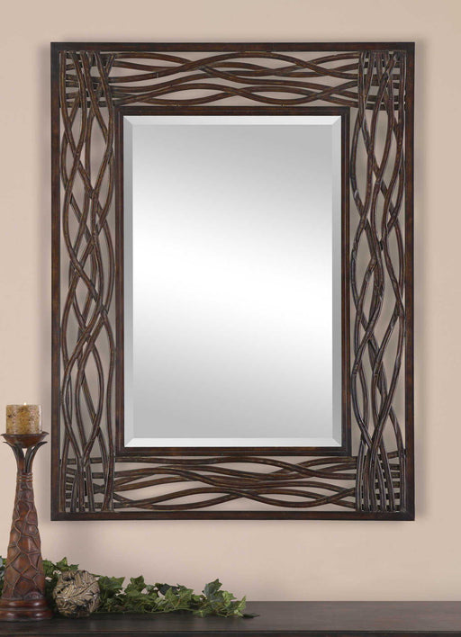 Uttermost Dorigrass metal wall mirror with a brown finish, featuring a modern round design and decorative metal frame.